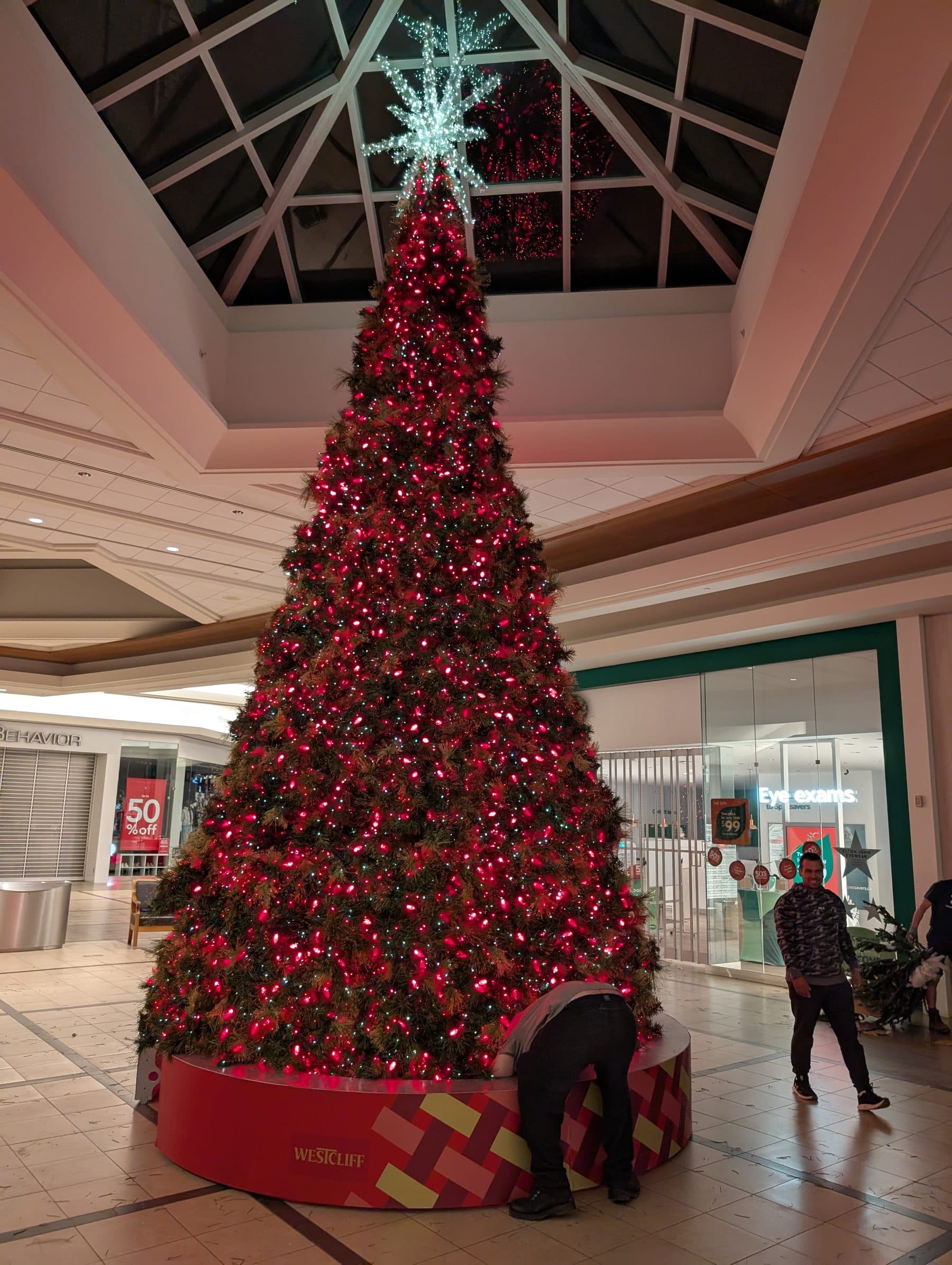 Giant red-lit Christmas tree in a shopping mall atrium