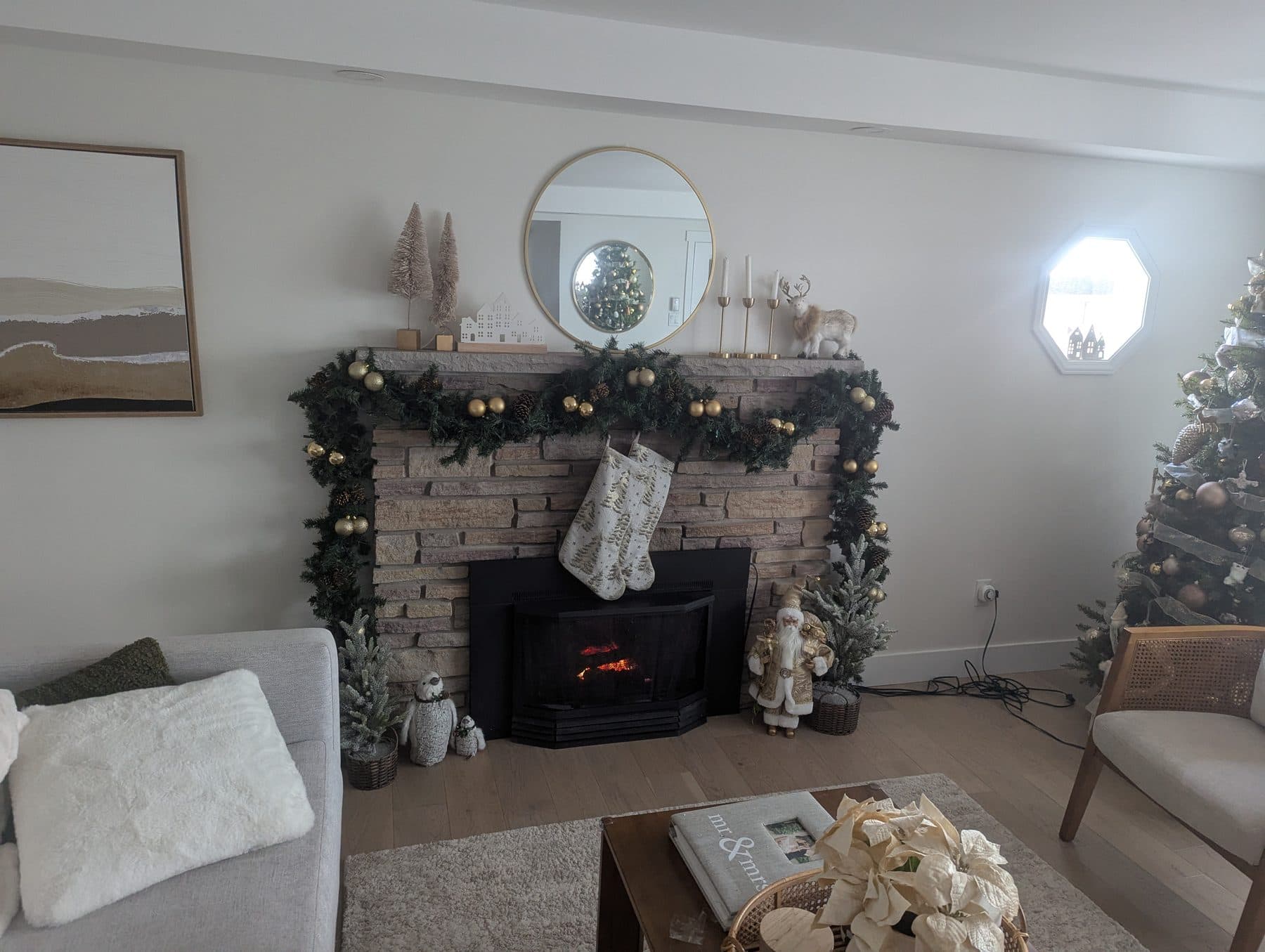 Styled fireplace mantel with a lit garland and neutral holiday decor